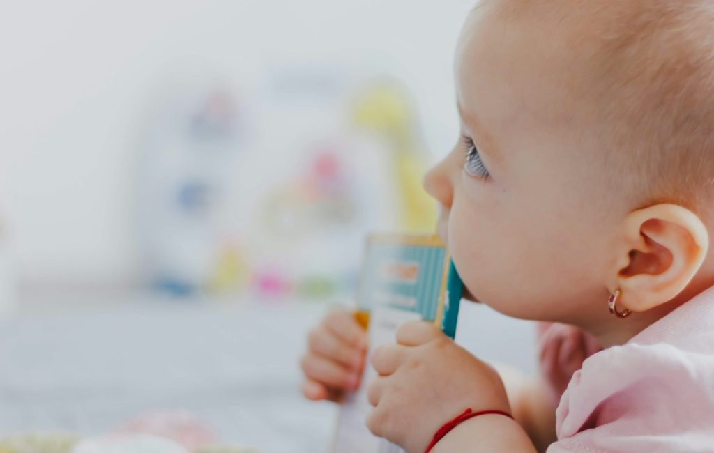 baby biting edge of book